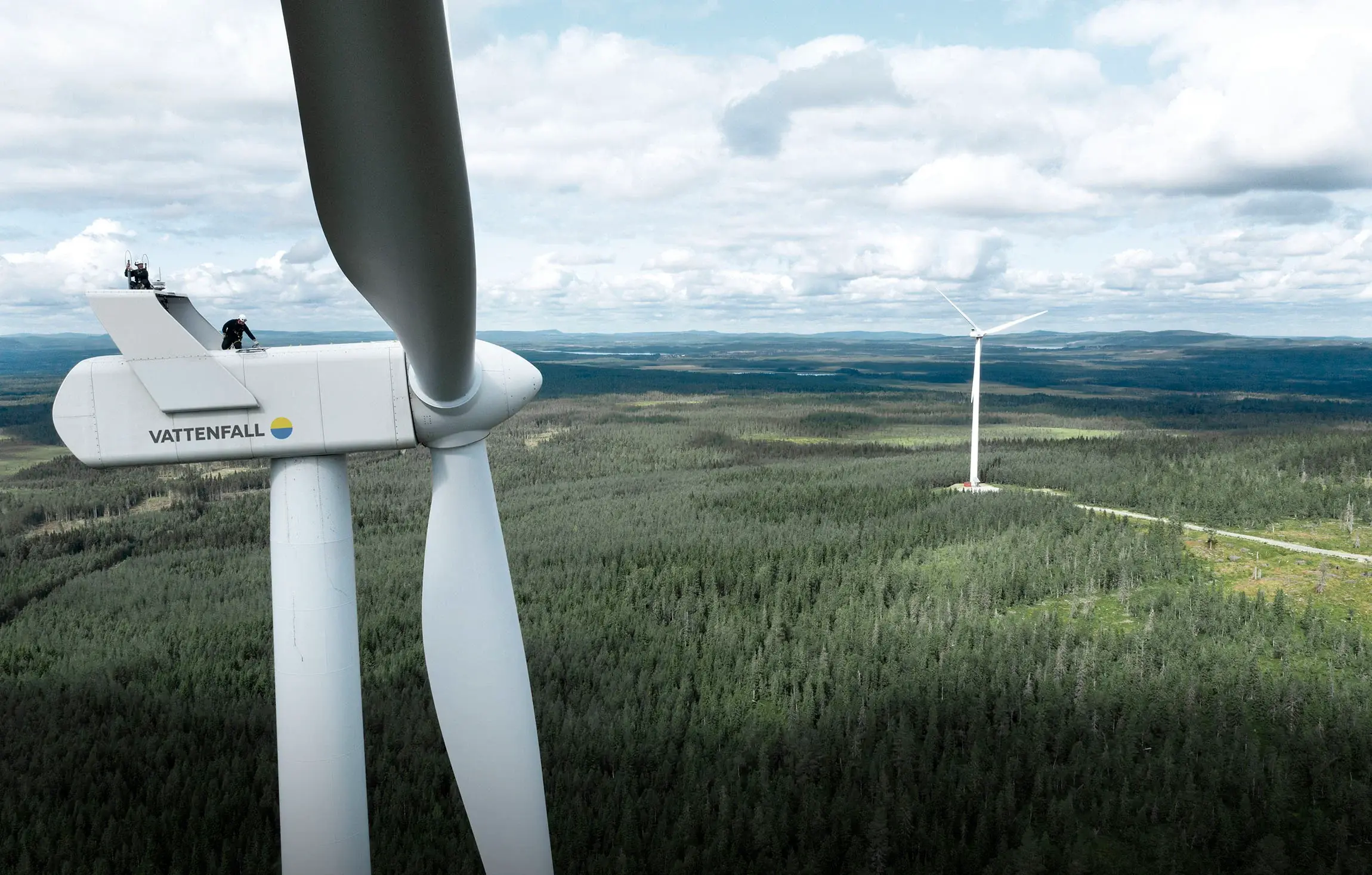 Vattenfall wind turbines above a Swedish forest